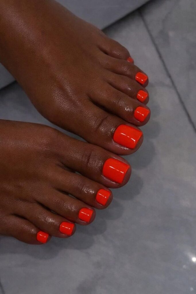 electric ornage toenails for dark skin